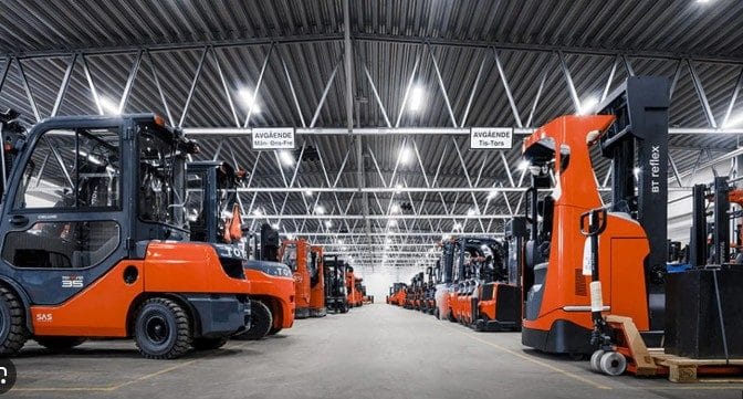 Warehouse environment with big orange forklifts